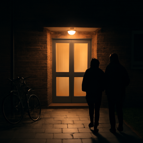 Lit entrance of a residential block in the evening